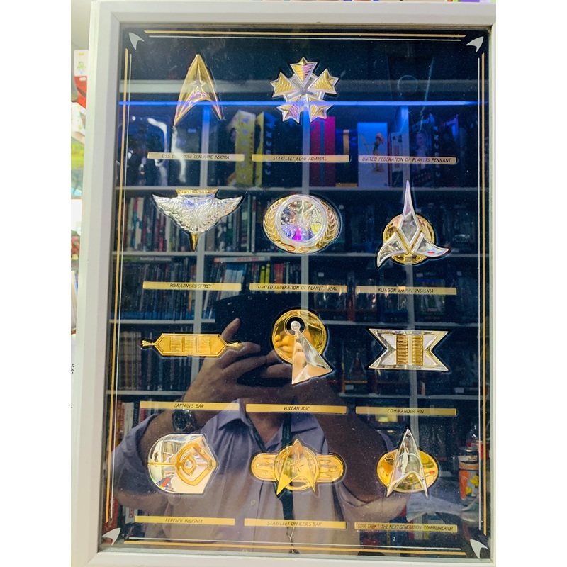 Star Trek Badges one missing in glass case